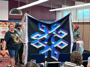 Rayna Fisher showing her quilt